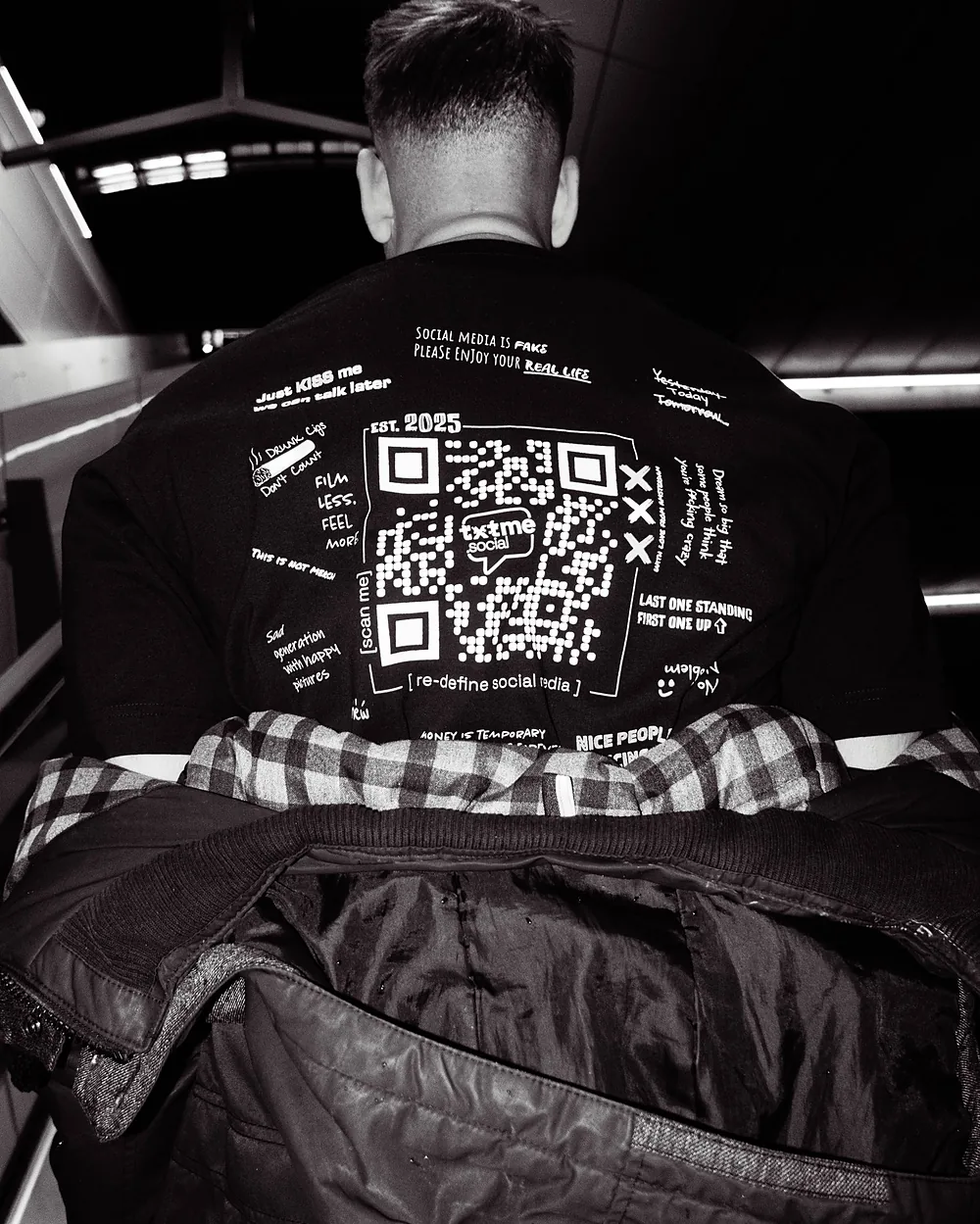 A code on a black shirt, late at night